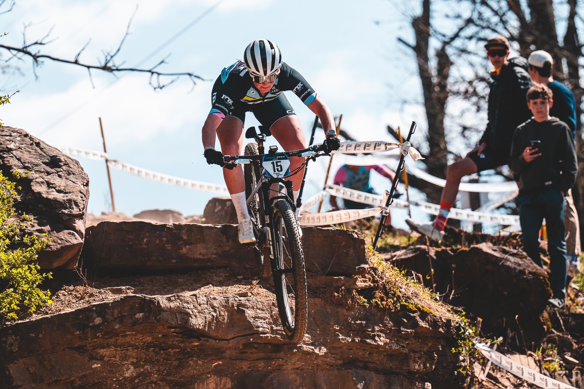 Bayli McSpadden racing through a technical rock section on the UCI World Cup circuit